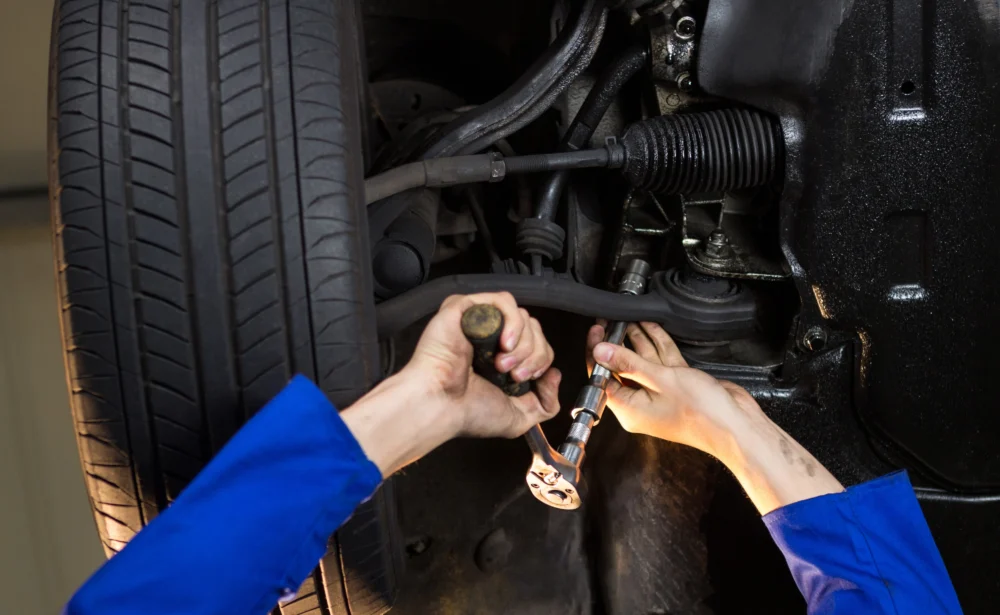 mechanic servicing car 1000x615